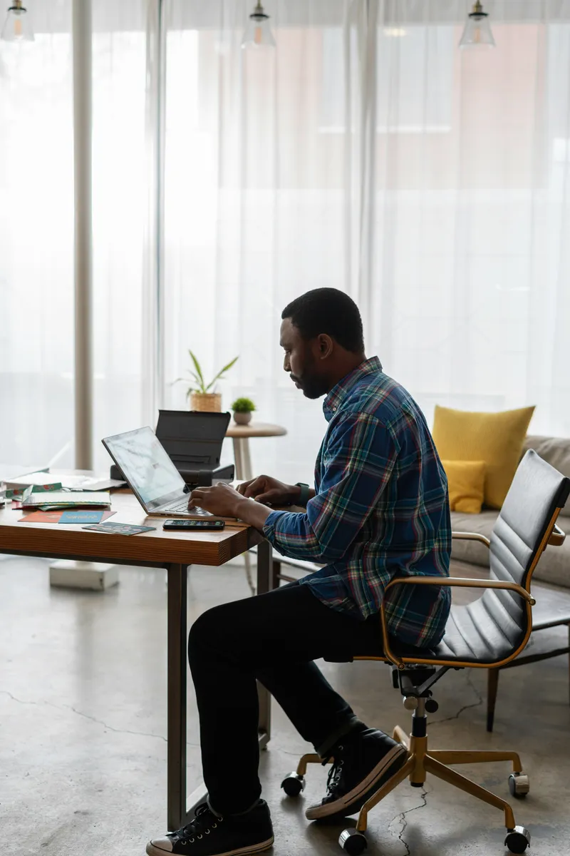 Man using laptop in modern office